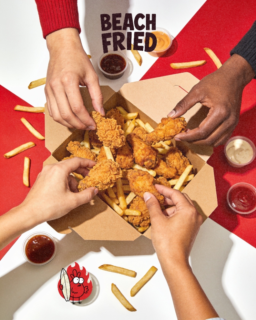 Hands sharing Beach Fried chicken box